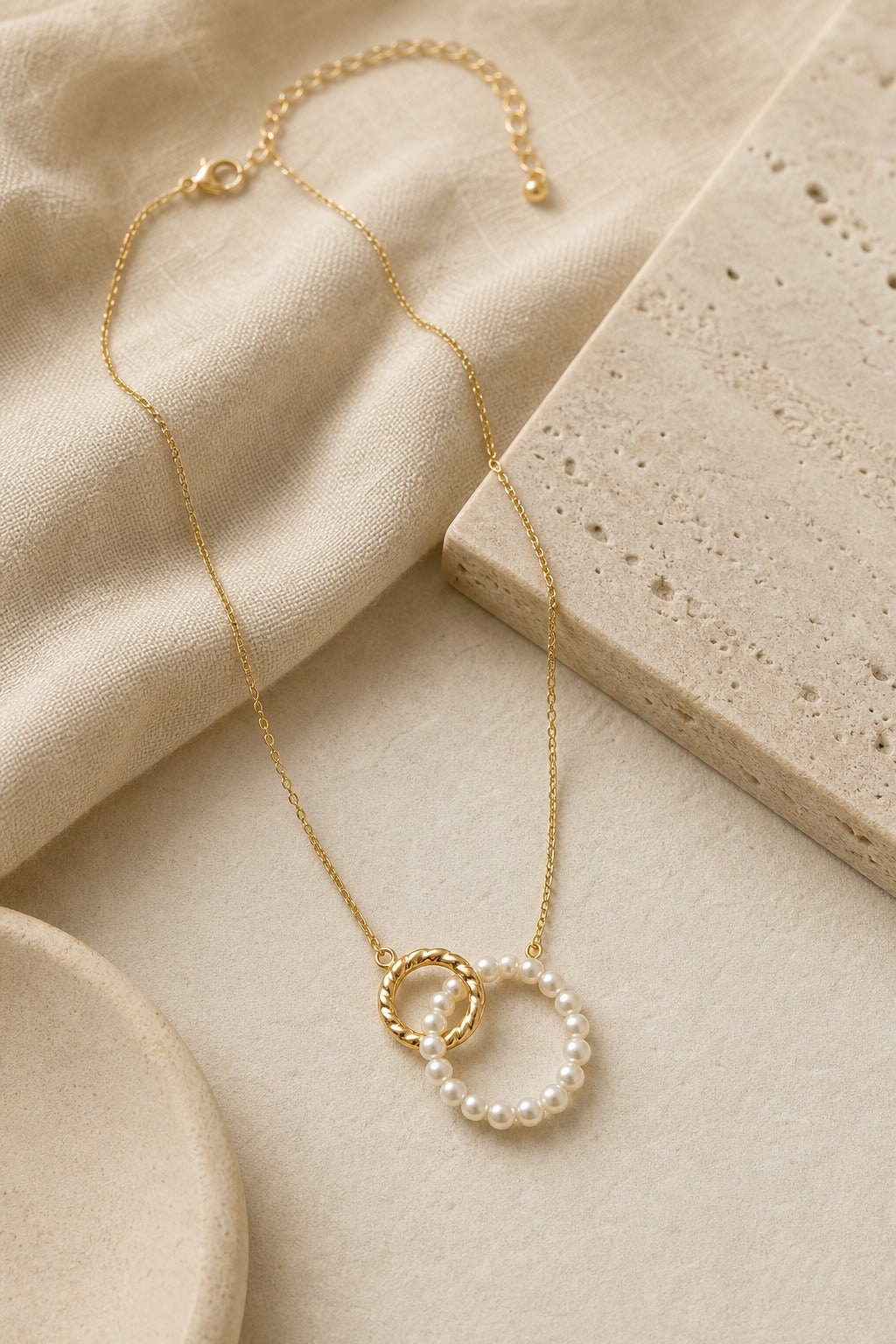Alba Pearl Pendant Necklace in White/Gold styled on ivory linen and stone for Avrienne