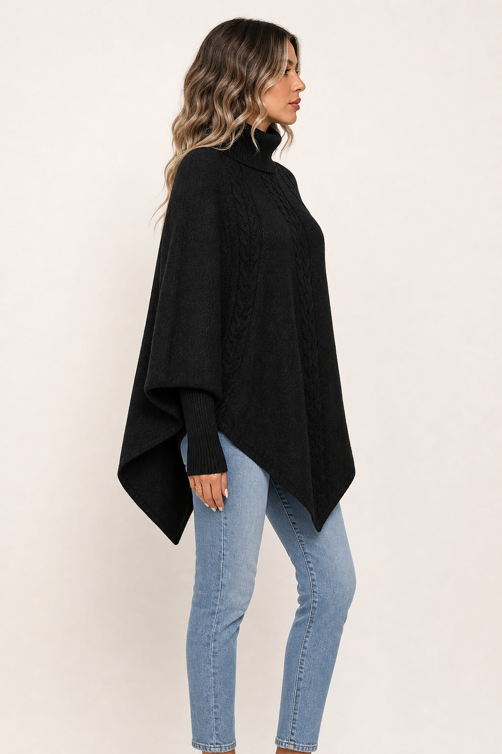 Florence Cable Cape Sweater in black opposite side view showing clean cape drape and cable knit texture